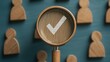 © Pairat - A magnifying glass with a check mark focuses on wooden figures, representing selection, validation, or approval in a conceptual setting.