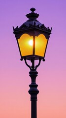 Wall Mural - Ornate street lamp casting a warm glow against a twilight sky