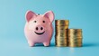 © Boraryn - A cheerful pink piggy bank next to stacks of coins, symbolizing saving and financial management.