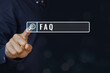 © sichon - Concept of FAQ, frequently, asked, questions and topic. A man touching the magnifying glass icon with the word FAQ