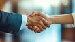 © EddieSnapix - A corporate executive engages in a firm handshake with a partner, highlighting a successful collaboration during a meeting at a conference venue, emphasizing their recent accomplishments