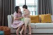 © Wosunan - A special child and his mom having fun and relaxing on a holiday together in the living room of the house
