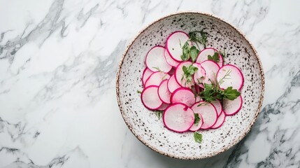 Wall Mural - Sliced radishes with herbs in a ceramic bowl on a marble background