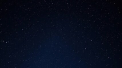 Wall Mural - an ethereal night sky with stars twinkling in shades of gold and blue against a deep indigo backgrou