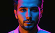 © Miklos - A man's face is illuminated by blue and pink light, creating a dramatic effect