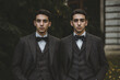 © Di Studio - two men brothers twins in suits outdoor