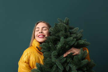 Sticker - Happy young woman with Christmas tree on green background