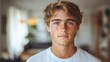 portrait of handsome blonde boy 15 years old in white T-shirt at home