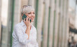 © Alen-D - 40s mid age blond woman on the mobile phone talking and resting on bench in the city. Adult female talks on the smartphone phone.