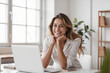 © Derek Brumby - Smiling Young Woman Working from Home at a Bright Workspace with Laptop
