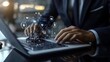 © George Louris  🜲 - A businessman uses a stylus on a laptop to interact with a virtual interface featuring icons for security, connectivity, and global access, symbolizing comprehensive digital management in a global