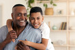 © Prostock-studio - Family Bonding. Portrait Of Happy Black Preteen Boy Embracing His Grandfather And Posing To Camera At Home, Selective Focus, Free Space