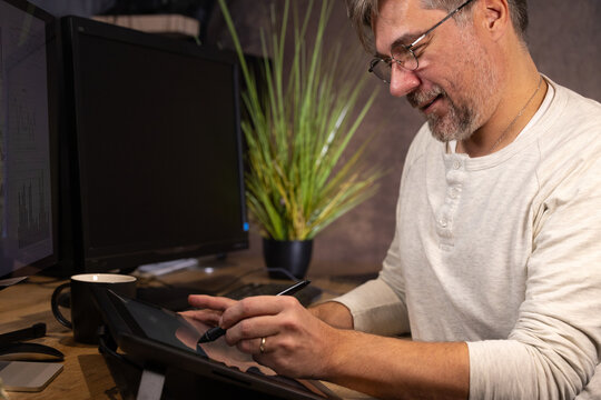 info graphiste, dessinateur ou employé de bureau souriant utilisant une tablette graphique pour dessiner ou travailler dans son bureau