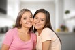 © BillionPhotos.com - Happy young female Friends hugging at home