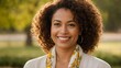 © Tianci - A woman with curly hair and a floral scarf smiles warmly at the camera, set against a blurred natural background.