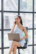 © David - Cheerful beautiful Asian woman in the office workplace with talking on the phone business finance concept.