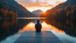 © Matt - Serene autumn sunrise over a mountain lake with a man sitting on a dock