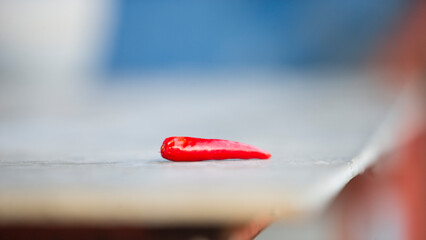 Wall Mural - Red hot chili pepper on wooden table