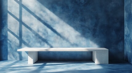 Wall Mural - minimalist white bench against a blue textured wall with sunlight streaming through a window.