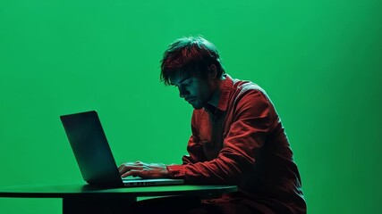 Poster - young man is intensely typing on his laptop against a vibrant green screen, offering endless possibi