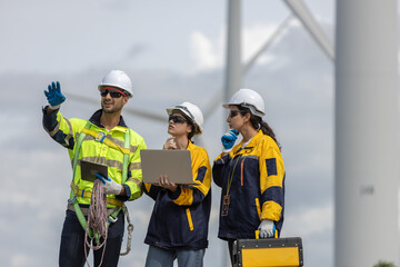 Fototapete - Engineer wearing safety uniform using tablet discussed plan about renewable energy at station energy power wind turbine. technology protect environment reduce global warming problems.