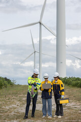 Fototapete - Engineer wearing safety uniform using laptop discussed plan about renewable energy at station energy power wind turbine. technology protect environment reduce global warming problems.