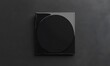© RM Graphics - Black closed disk cover mockup, isolated on dark background, 3d rendering. Empty dvd packaging mockup, top view