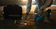 © peopleimages.com - Crime scene, person and hands with swab for evidence, DNA sample and clue in abandoned warehouse. Forensic specialist, PPE suit or investigation in building for legal service, inspection or pathology