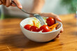 © Lomb - Fresh vegetable salad macro tomatoes lettuce fork eating healthy food bowl closeup nutrition diet