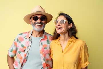 Wall Mural - A man and a woman are smiling and wearing sunglasses