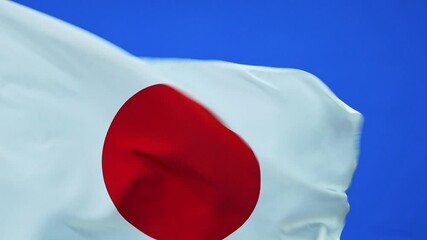 Wall Mural - Slow motion video of Japan flag waving on blue background