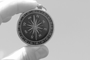 Wall Mural - round compass in hand on abstract background