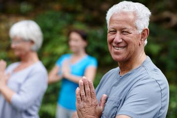 Wall Mural - Park, portrait or old man with prayer hands in yoga class for energy, balance or inner peace. Group meditation, face or happy elderly person in nature with spiritual healing, smile or mindfulness