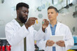© Westend61 - Pharmacists discussing and examining vials in pharmacy