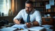 © angel_nt - man in formal attire attentively examines a stack of papers while seated at his desk, surrounded by books and office supplies, reflecting a productive work environment in an office
