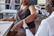 © Seventyfour - Cropped shot of unrecognizable African American woman in doctors office with dermatologist examining skin and moles using magnifying glass for skin cancer prevention copy space