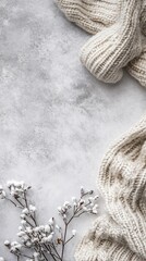 Wall Mural - Cozy winter background with knitted sweater and snowy branches framing empty space