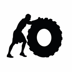 Wall Mural - A man is pushing a tire. The tire is black and white. The man is wearing shorts