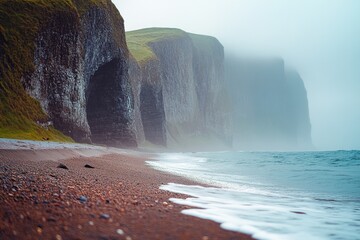 Wall Mural - A person stands at the edge of a cliff overlooking the ocean, with the sun setting in the background