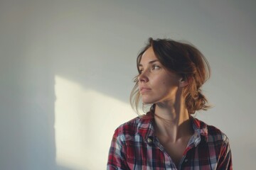 Wall Mural - A woman stands in front of a plain white background, ideal for showcasing her outfit or as a minimalist composition