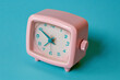 © Marina Demidiuk - Vintage Pink Alarm Clock on a bright Turquoise Background. Retro alarm clock on a light blue backdrop. Nostalgic. Deadline time concept. Daily routine. 70s Retro Plastic Clock. Time management