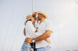 © Jordi Salas - A happy couple smiling and embracing, enjoying a romantic moment on a sailboat, creating a joyful and relaxed atmosphere.