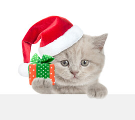 Poster - Cute tiny cat holding gift box above blank white banner. isolated on white background