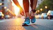 © Mobasser - Wearable fitness tracker with wearable smart technology, Urban runner, tying shoelaces, city street at sunset