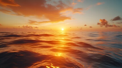 Wall Mural - Tranquil ocean scene capturing sunset reflection on rippling water surface, featuring golden hour colors, shimmering waves, and warm orange glow with dramatic sky.