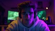 © Mykhailo - Young man with a focused expression live streaming a gaming marathon in a dark room, wearing headphones and a casual hoodie, surrounded by glowing monitors with purple and green RGB lighting.