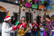 © Marcos - mexican family Singing carols in Christmas eve and celebrating traditional Posadas in Mexico Latin America, hispanic culture and people