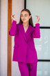 © Andrey_Arkusha - Fashion portrait of a young beautiful brunette girl in magenta suit