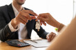 © Pormezz - Realtor agent giving a key of apartment to new owner after signed lease agreement.