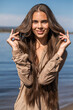 © Andrey_Arkusha - Portrait of a young brunette woman posing in beige tunic